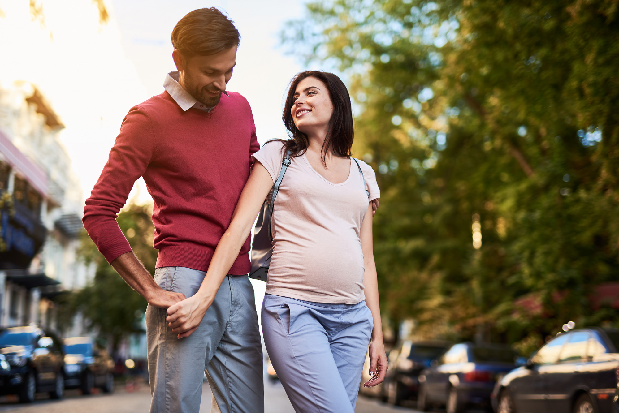 Pregnant couple holding hands