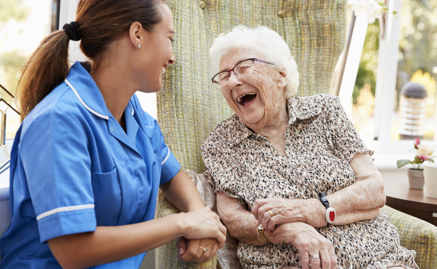 Nurse laughing with old lady