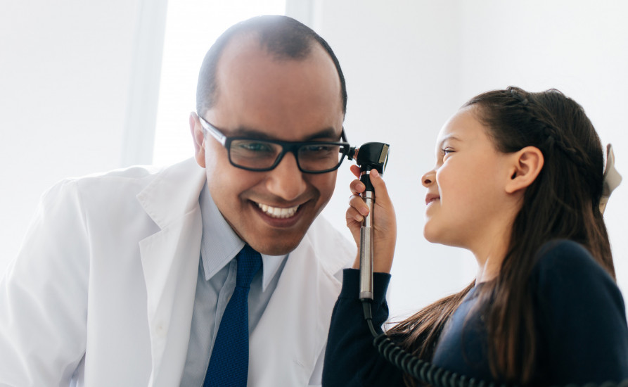 Doctor playing with little girl