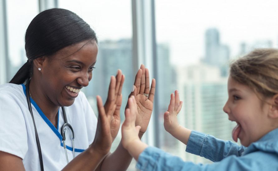 nurse high fives little child