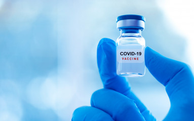 NPI - Vial in hand with Covid vaccine