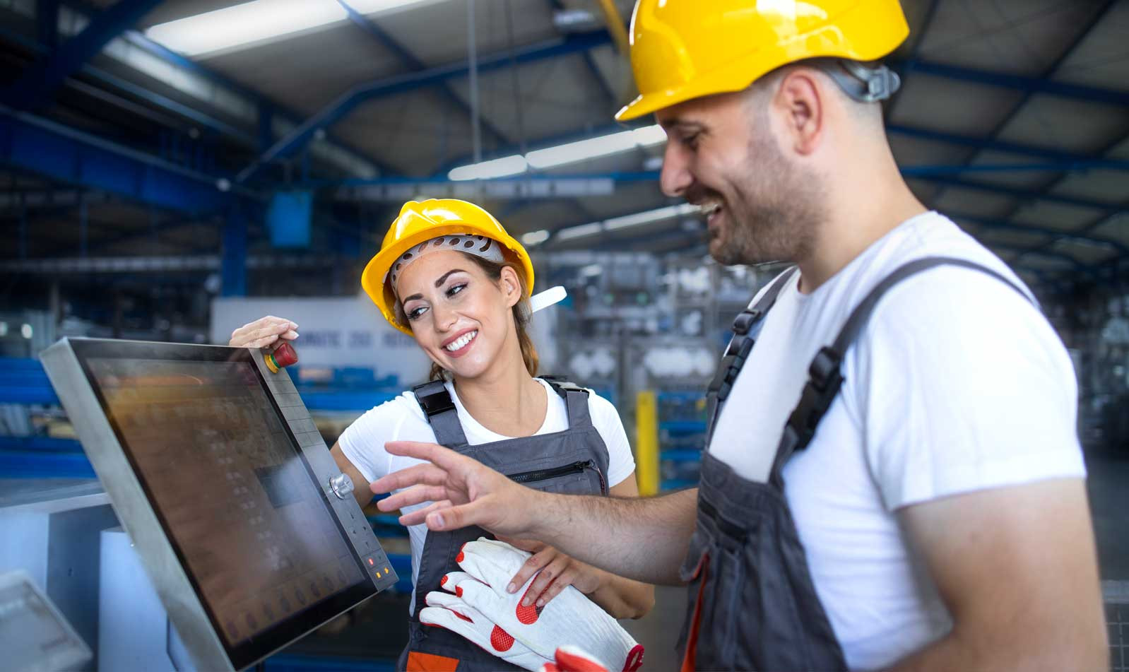 Two workers operating on machine